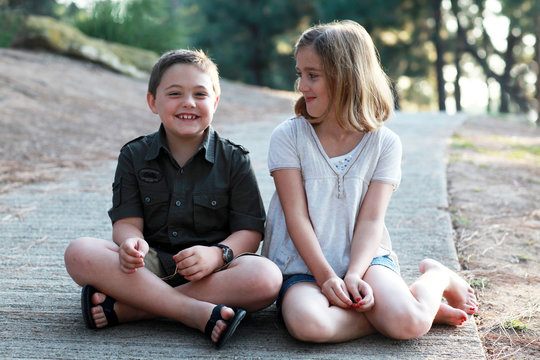 Young girl smiling looking at laughing boy