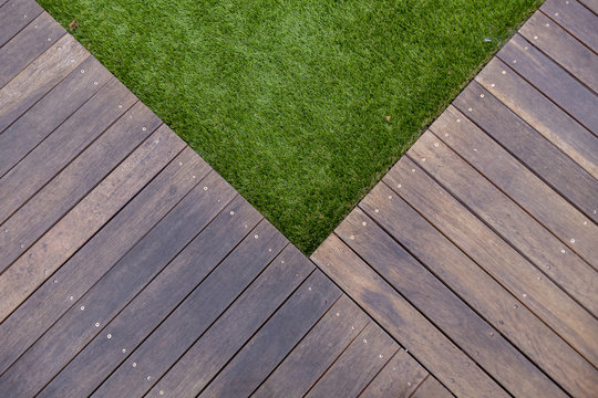 Timber decking border on synthetic grass