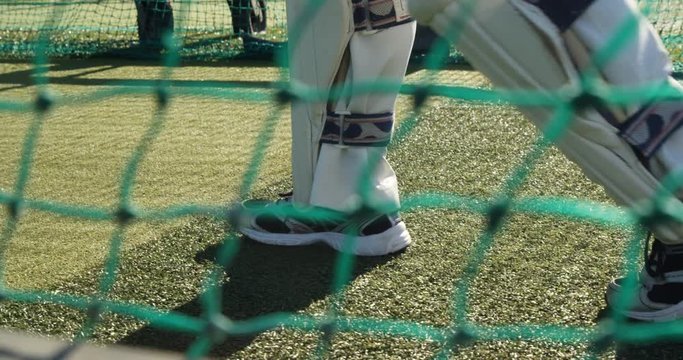 Cricket player walking on the pitch during a practice session