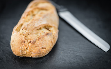 Rustic slate slab with Fresh baked Baguette (selective focus)