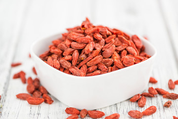 Goji Berries (selective focus) on vintage wooden background