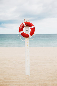 Lifering stand on a beach