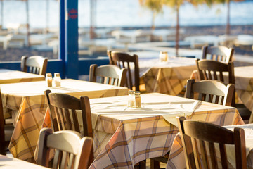 Outdoor cafes in coastline resort Kamari in Santorini Greece