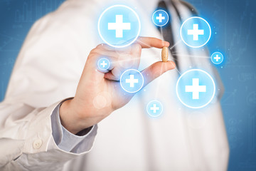 A doctor showing a pill with crosses