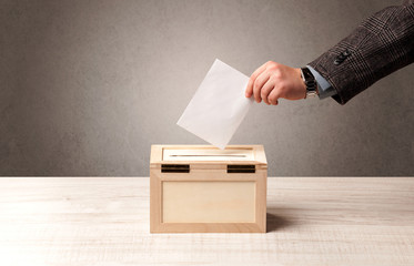 Ballot box with person casting vote