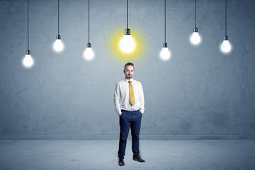 Businessman standing uninspired with bulbs above