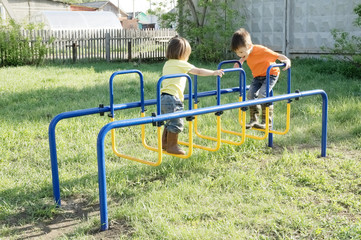 Children playing outdoors. Boy and little girl on playground, children activity. Active healthy childhood concept