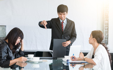 Group of aisa startup business meeting about the results of business revenue, profits and Boss show thumbs down to say tha tbad business in business and startup concept.