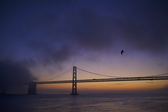 Fog rolling in over the San Francisco Bay Bridge.