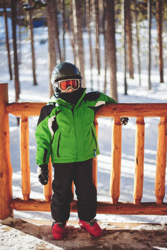 Boy dressed in ski clothes with helmet and googles