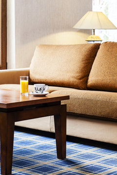Drinking orange juice and coffee in luxury hotel interior