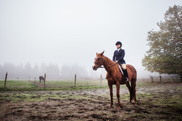 Woman riding her horse outside on the field