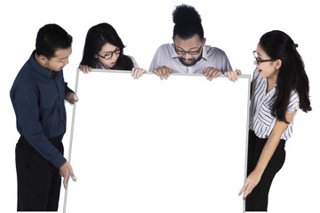 Cheerful business team looking at a billboard