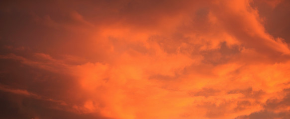 Naklejka na ściany i meble Red clouds at sunset.