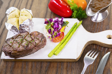 Grilled beef steak on wooden table