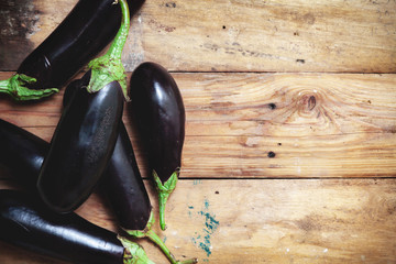 Several ripe eggplant lay on boards © glebchik