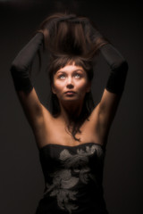 black hair woman portrait on dark background