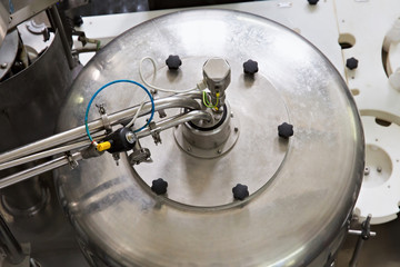 Industrial dairy production. Part of automatic conveyor with bottles for milk.