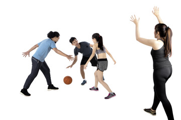 Multiracial people playing basketball
