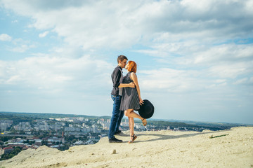 couple stand on the top of the peak