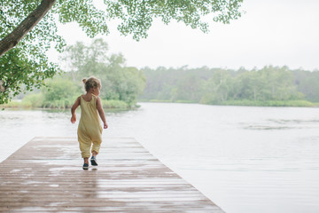 little girl exploring on a dock