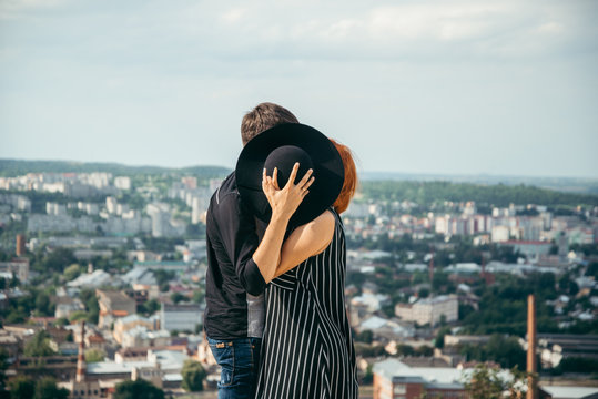 Woman Kiss Boyfriend While Hiding Behind The Hat