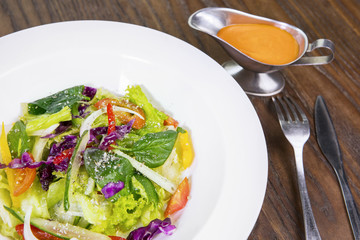 Salad with sauce on table