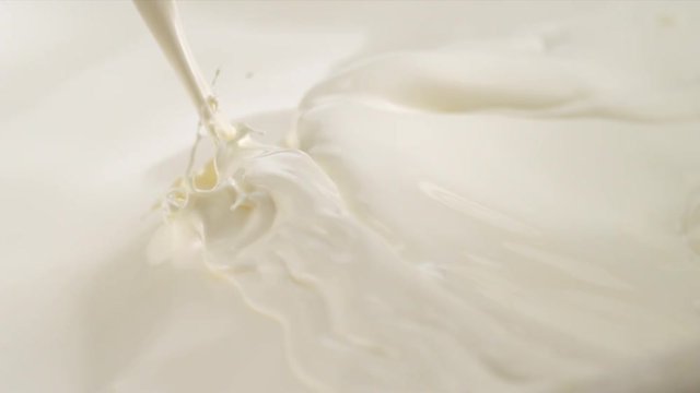 Pouring Milk closeup. Milk Splesh Slow Motion.