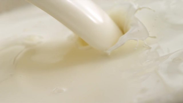 Pouring Milk closeup. Milk Splesh Slow Motion.