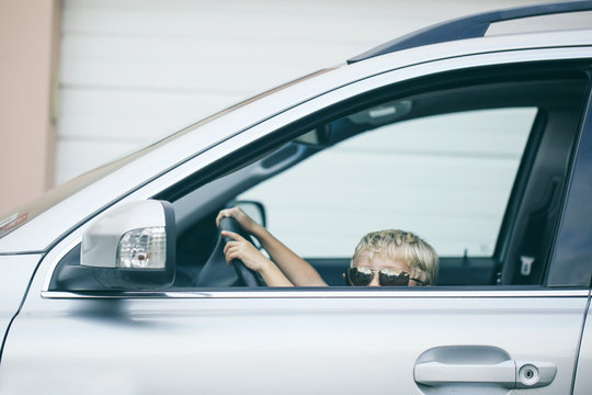 boy pretends to drive a vehicle
