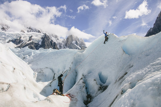 Man climbing on ice wall on a glacier in Patagonia, Argentina. Adventure sport