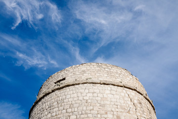 The Old Toljevac Fortress Tower under the cloudy blue sky in Mali Ston, Croatia.