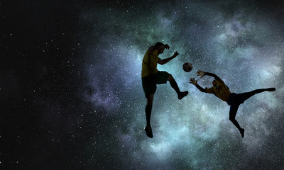 Silhouettes of two soccer players
