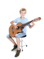 blond teen boy with guitar in studio against white background