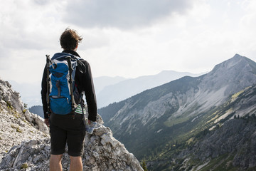 Hiking man enjoying the view of the mountain scenery