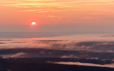 Sunset landscape. View of the misty valley