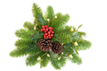 Winter holly, fir, ivy, mistletoe and pine cones on white background.