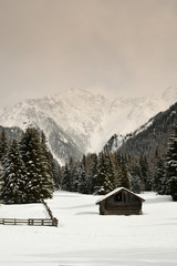 alpine huts in winter in the dolomites. italy