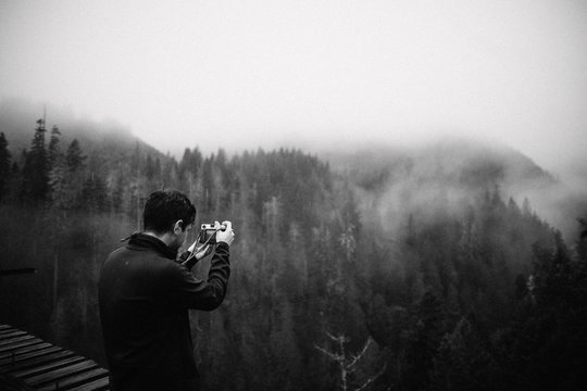 Man taking photos in forest