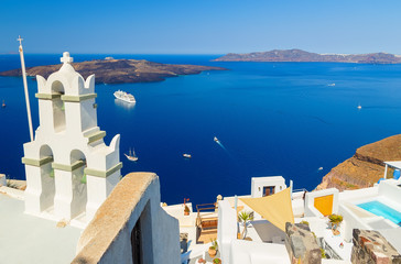 Bell tower of Orthodox church with view over volcanic caldera at Fira, Santorini Island, Greece