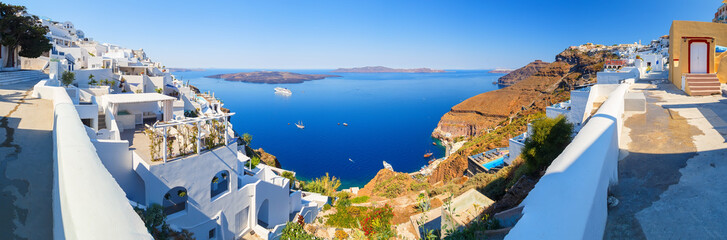 Fira panorama with caldera, hotels, restaurants, houses and cruise ships in the Bay from Fira town, Santorini, Greece