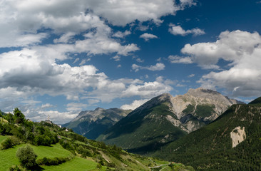 the mountains of the lower Engadin valley in Switzerland near Scuol with a view of the valley and the village of Sent and its church
