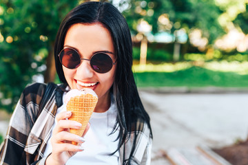 Pretty long hair brunette girl enjoy ice cream on the street