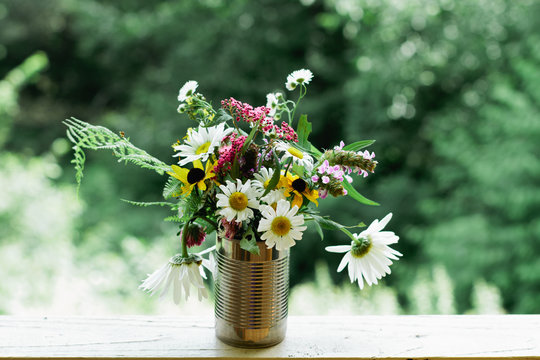 wild flower bouquet in tin can
