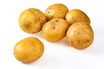 Pile of fresh, yellow, ripe potatoes, isolated on white. Close up
