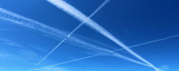 White airplane trails in the sky