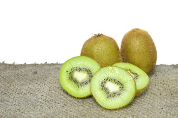 Ripe whole kiwi fruit and half kiwi fruit isolated put on brown sack