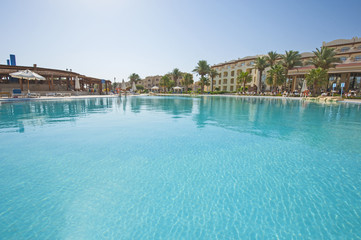 Fototapeta na wymiar Large swimming pool at luxury tropical hotel