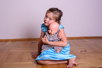 girl plays with a doll