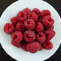  raspberries on white plate